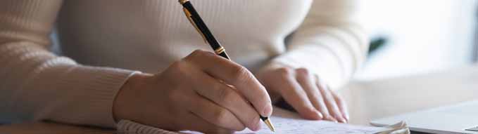 Close up student girl sit at desk holding pen makes notes on exercise book, do task prepare for college exams, female entrepreneur write down important data information creative start up ideas concept