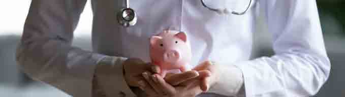 Close up young female doctor therapist wearing white coat uniform and stethoscope holding pink piggy bank, healthcare money savings, medical insurance concept, hospital budget and accounting