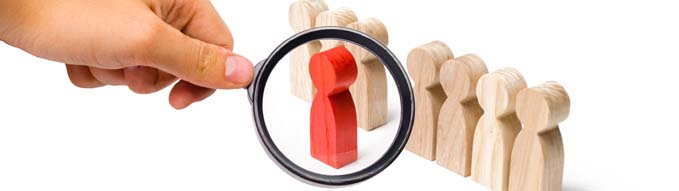Magnifying glass is looking at the red figure of a man comes out of the line of people. Talent, leader, professional. improvement in work, the universal recognition of efficiency and leadership