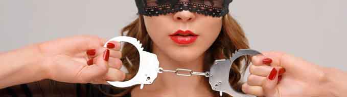 Sexual woman holding handcuffs.