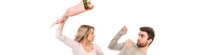 The man and a woman fight with flowers on the white background