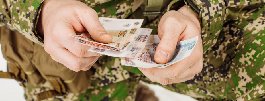 Soldier serviceman with russian ruble money his hand.