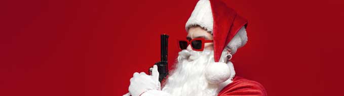 santa claus in hat and festive glasses holds gun in his hands on red background, dangerous man in santa costume with weapon threatens