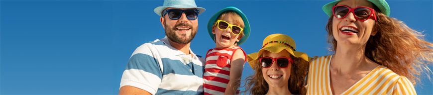 Happy family having fun against blue sky background. Mother, father, daughter and son on summer vacation