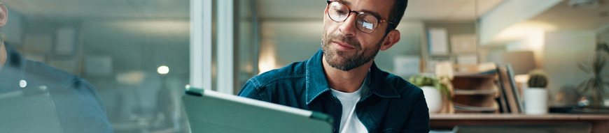 Tablet, glasses and laptop with business man in office for planning, ui designer and app review. Developer solutions, client feedback and research with person in agency for project idea and startup